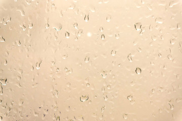 Drops of rain on glass , rain drops on clear window / water drops on glass after rain background / water drops / Small water drops on the glass