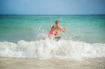 happy couple in the sea and the waves