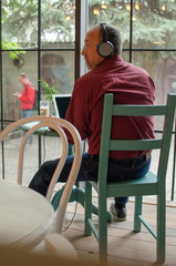 Aged man listening to music