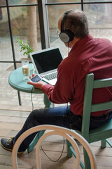 Aged man listening to music