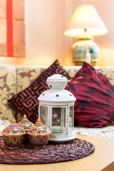 thai handcraft bowl, white lamp, flowers pattern fabric sofa & vintage green pottery floor lamp in asian oriental living room for interior concept