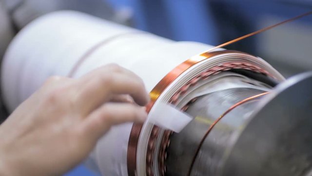 Copper wire wound, wrap copper coil, making electrical coil of a transformer. High-voltage transformer production. HD.