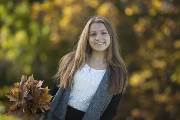 Girl with a cute smile on  sunny autumn day