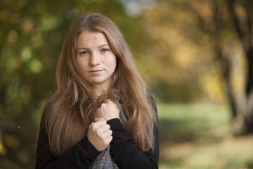 Girl with a cute smile on  sunny autumn day