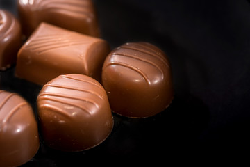chocolate candies isolated on black