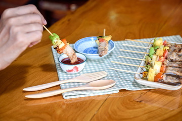 girl eating Pork Bar B Que(BBQ)