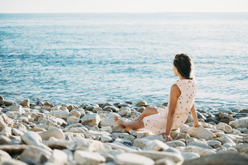 Woman resting on pebble coast