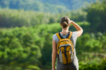 Fototapeta premium Young traveling woman with backpack. focus on traveller