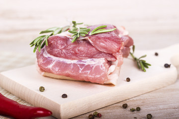 Fresh meat : raw pork  with red chili pepper, dill and rosemary on wooden board