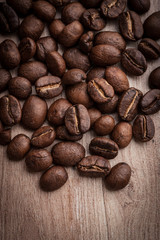 roasted coffee beans on wooden background, can be used as a background
