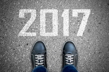 Black casual shoes and direction sign to 2017