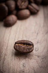 roasted coffee beans on wooden background, can be used as a background