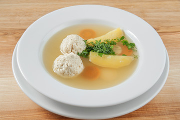 soup with meatballs in a bowl, sprinkle with herbs