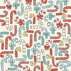 Seamless christmas pattern with hand drawn candy canes in different colors. Doodles in simple graphic style. Vector decorative illustration in blue and red colors on beige background.