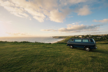 Fototapeta na wymiar Old vintage van parking at the coastline of Cornwall, England