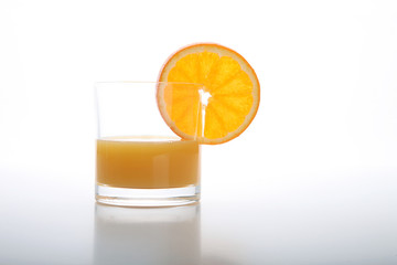 Orange juice and slices of orange isolated on white