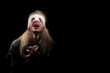 scared bloody girl screaming on black background with copyspace