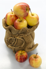 red apple in bag on white table