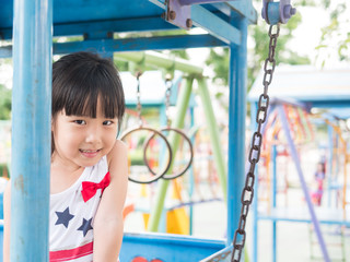 Happy asian baby child playing on playground