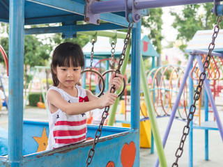 Happy asian baby child playing on playground
