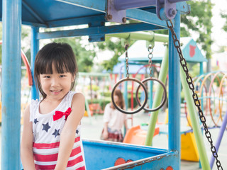 Happy asian baby child playing on playground