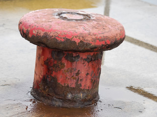 Rusty red mooring post