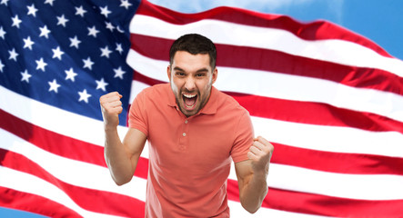 angry man showing fists over american flag