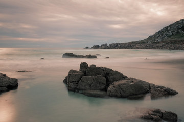 Fototapeta na wymiar Long exposure shot of rocky beach in Cornwall, England