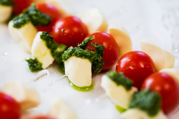 close up of mozzarella and cherry tomato canape