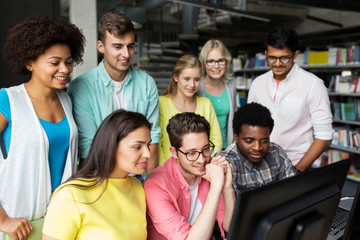 international students with computers at library