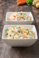 Russian salad on a rustic wooden table

