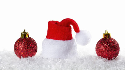 Fototapeta na wymiar Christmas background with Christmas balls and cap of Santa Claus