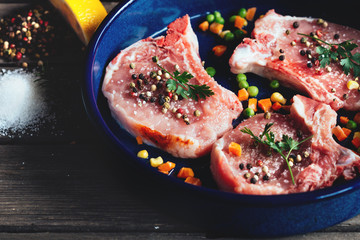 Raw meat on the vintage table and old vintage frying pan
