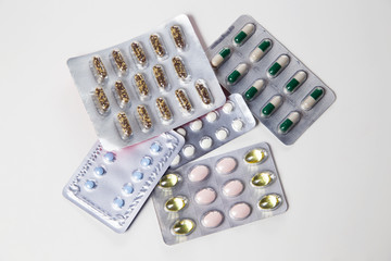 Medicine pills or capsules with syringe on white background. Drug prescription for treatment medication. Pharmaceutical medicament. Injection with vaccine