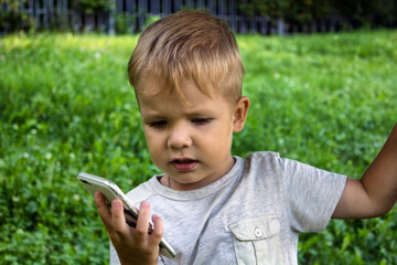 Small boy uses big phone