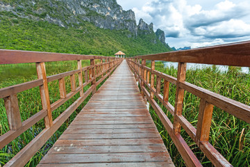 Fototapeta na wymiar Beautiful of wooden bridge and lake in Sam Roi Yot National Park, Prachuap Khiri Khan, Thailand