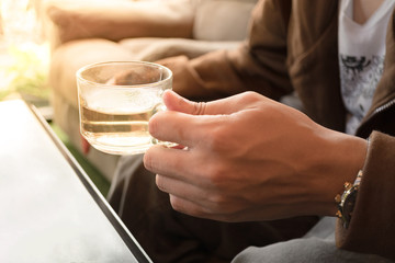 Close up of man hands holding hot tea cup