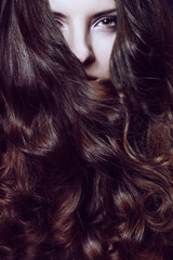 girl's portrait with curled hair, the close up, hair cover the face