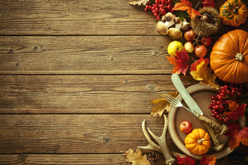 Autumn background from fallen leaves and fruits with vintage pla