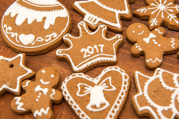 Obraz na płótnie Canvas Christmas homemade gingerbread cookies over wooden table. 2017. Selective focus