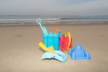 Colorful toys for childrens sandboxes against the sea and beach