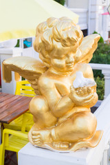 Golden angel statue with white dove