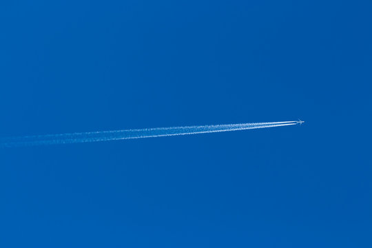 Reversing the trace of the plane in the blue sky without clouds