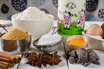 Ingredients for baking cake, on a wooden rustic background.