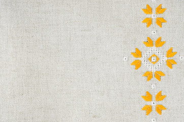 Texture of the vintage flax with embroidery. Design of ethnic pattern.