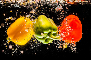 splashing bell peppers on water
