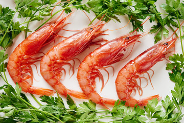 Raw prawns and parsley on white dish
