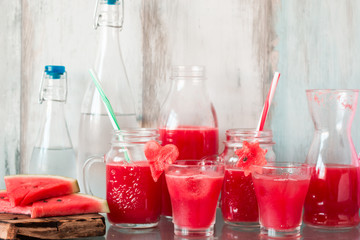 Watermelon drink in glasses with slices of watermelon mint and lemon,