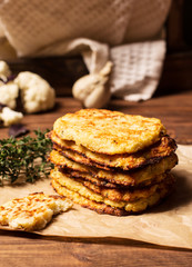 Hash browns cauliflower on a brown wooden background, selective focus, horizontal vertical