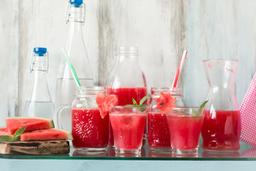 Watermelon drink in glasses with slices of watermelon mint and lemon,
